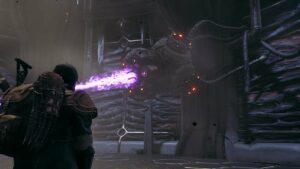 The player character stands back from a giant robot eye as it shoots a giant purple laser