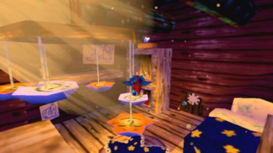 Crítica do Cavern of Dreams Switch – Fynn, o dragão, pulando através de plataformas em um quarto com uma cama no canto