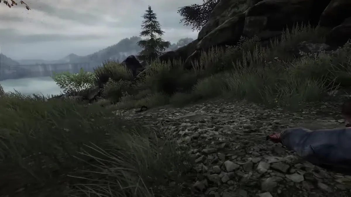 Uma mão ensanguentada se estende em um caminho em O desaparecimento de Ethan Carter. 